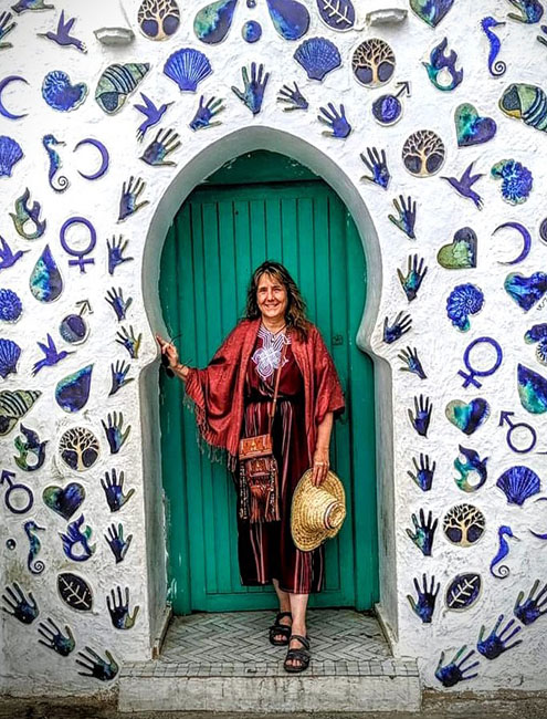 Maggie Peyton standing in front of a green door.